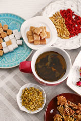 Cup of tea with aromatic dry tea on wooden background
