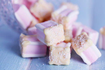 Tasty marshmallows with chocolate in bowl on table, close up