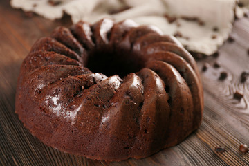 Chocolate cake on wooden background, closeup