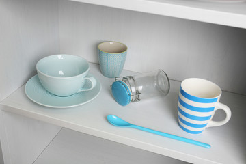 Tableware on shelf in the kitchen cupboard