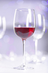 Wineglasses on blurred lights background