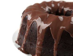 Ring chocolate cake with glaze in plate closeup
