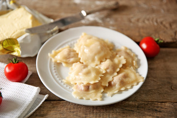 Cooked ravioli and tomatoes on plate