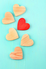 Wooden hearts on color wooden background