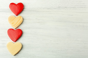 Wooden hearts on light background