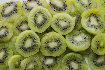Fresh organic Kiwi Fruit Slices arranged showing the pips & structure