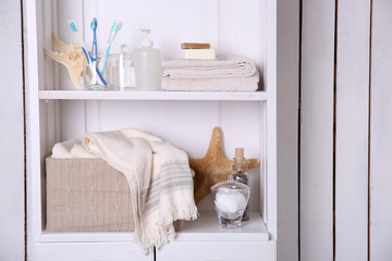 Bathroom set with towels, soap and starfish on a light shelf