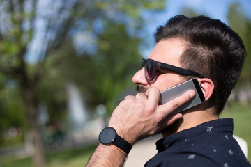 young handsome attractive bearded model man using smartphone in