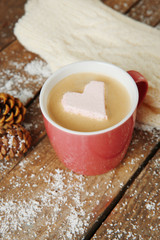 Cup of coffee with marshmallow on wooden table