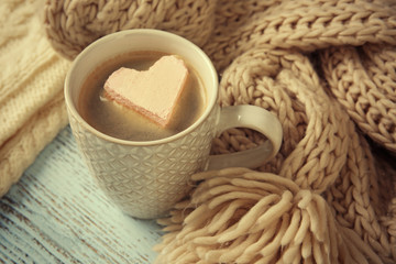 Cup of coffee with marshmallow on wooden table