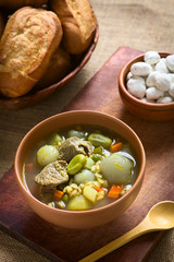 Traditional Bolivian soup called Chairo de Tunta (tunta is a freeze-dried potato typical in the Andean regions) made of tunta, beef, broad beans, peas and carrots (Selective Focus)