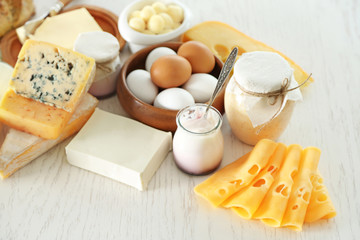 Set of fresh dairy products on white wooden table