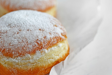 Fresh homemade donuts with powdered sugar, close up