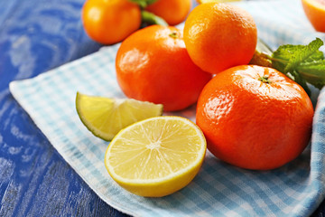 Juicy composition of sliced citrus on blue wooden background