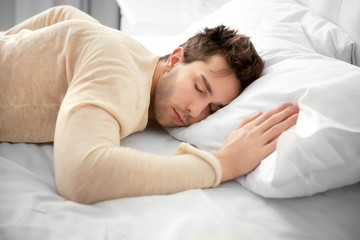 Fototapeta na wymiar Dressed man sleeping on the bed.