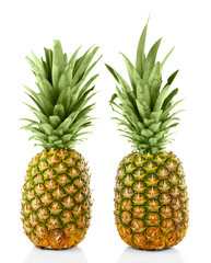 Fototapeta premium Two ripe fresh pineapples, isolated on white