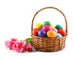 Multicoloured Easter eggs in basket isolated on white