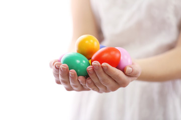 Fototapeta na wymiar Female hands holding Easter eggs isolated on white