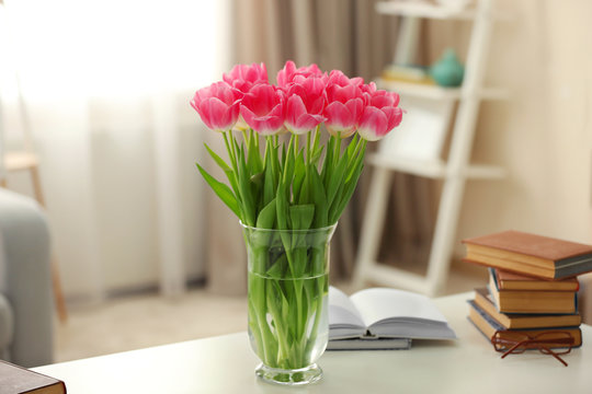 Spring bouquet of pink tulips on a white table.