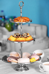 Cake stand with different sweets and tea
