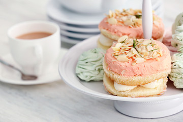Cake stand with different sweets and tea