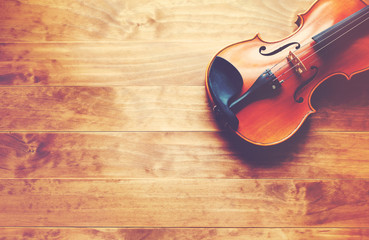 Violin on a wooden textured table