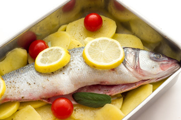 Fish with lemon potatoes and tomatoes ready for the oven