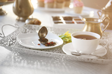 Delicious tea and cakes on wooden table, closeup