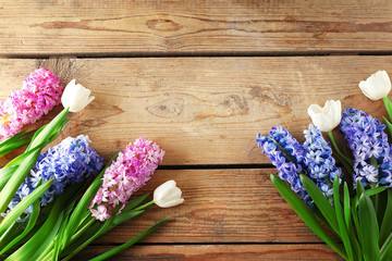 Composition of hyacinth and tulips on wooden background