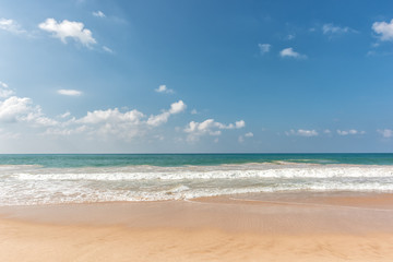 Fototapeta na wymiar tropical beach and wave against blue sky background