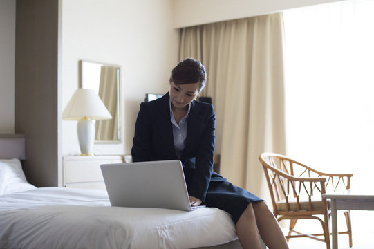 Women are working in the personal computer in the hotel's business trip destination