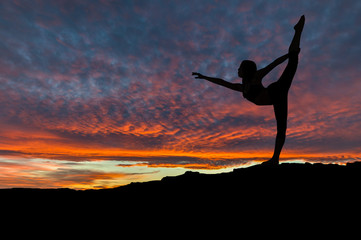 Silhouette of Woman Dancing Outdoors at Sunset