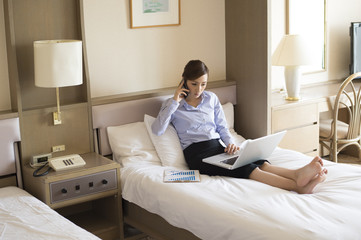 Women have to work sitting in the business hotel bed