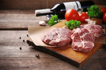 Marbled beef steak and spices on wooden background