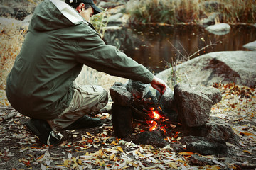 Man making fire in mountains
