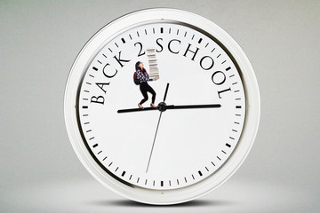 Young student carries books on the clock