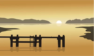 Fotobehang Pier Bij zonsopgang in zee met pier silhouet