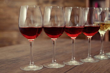 Many glasses of different wine in a row on bar counter