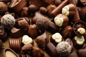 Assortment of delicious chocolate candies background, close up