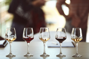 Many glasses of different wine in a row on a table. Tasting wine concept