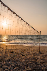 Volleyball net on the beach at sunset time