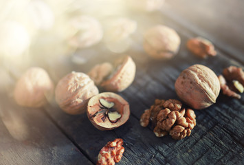 walnuts, whole and peeled wooden background