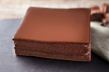 Delicious chocolate cake on cutting board closeup
