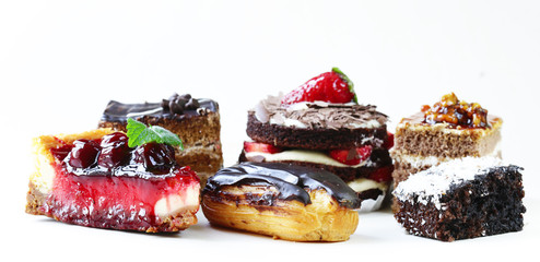 Assorted desserts, cakes and pastries on a white background