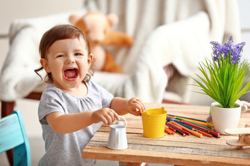 Little girl playing with toys in the room