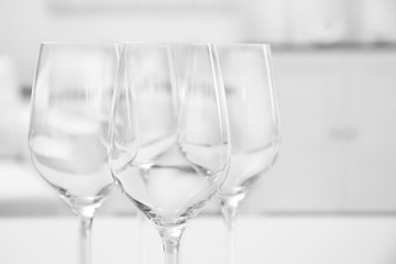 Wineglasses on blurred interior background