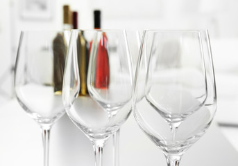 Wineglasses on blurred interior background