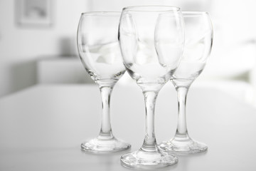 Wineglasses on blurred interior background