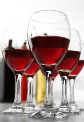 Glasses of red wine on white table closeup