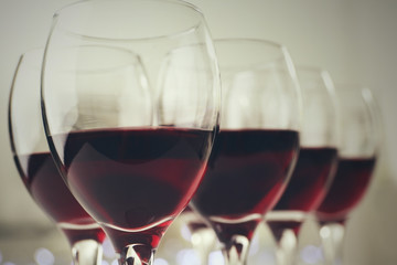 Glasses of red wine on white table closeup